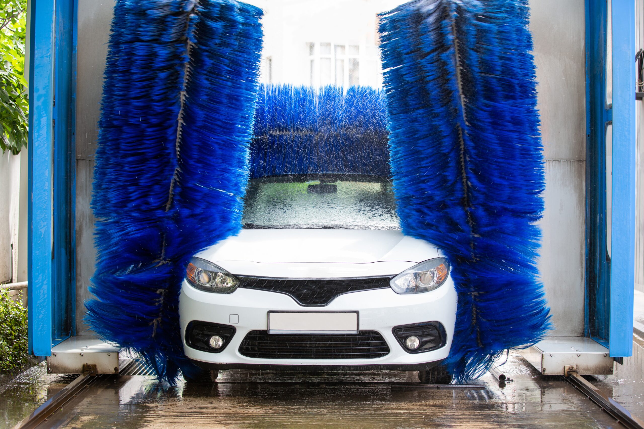 A white car going through an express car wash
