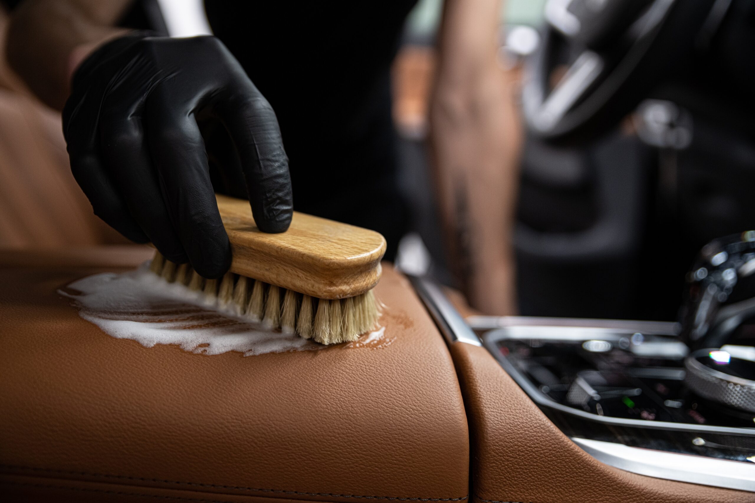 A technician performing an interior car cleaning